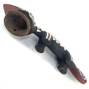 raditional wooden mask with bold linear carving