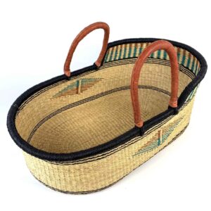 Natural elephant grass Moses basket with tan leather handles.