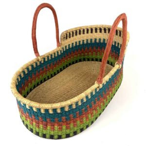 Natural Moses basket with leather handles photographed from above.