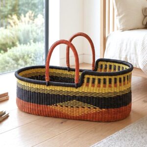 Handcrafted Ghanaian Moses basket with natural woven construction.