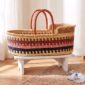 Natural elephant grass Moses basket with sturdy leather handles.