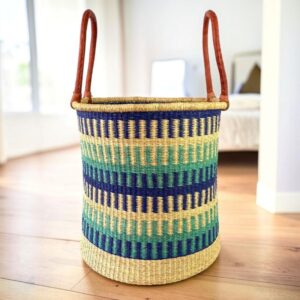 Open Bolga laundry basket with a patterned weave and leather handle detail