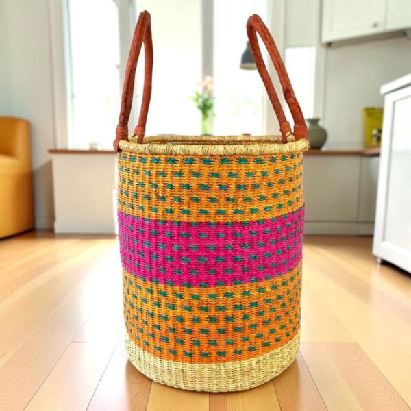 Open weave laundry basket with a patterned design and leather carry handles