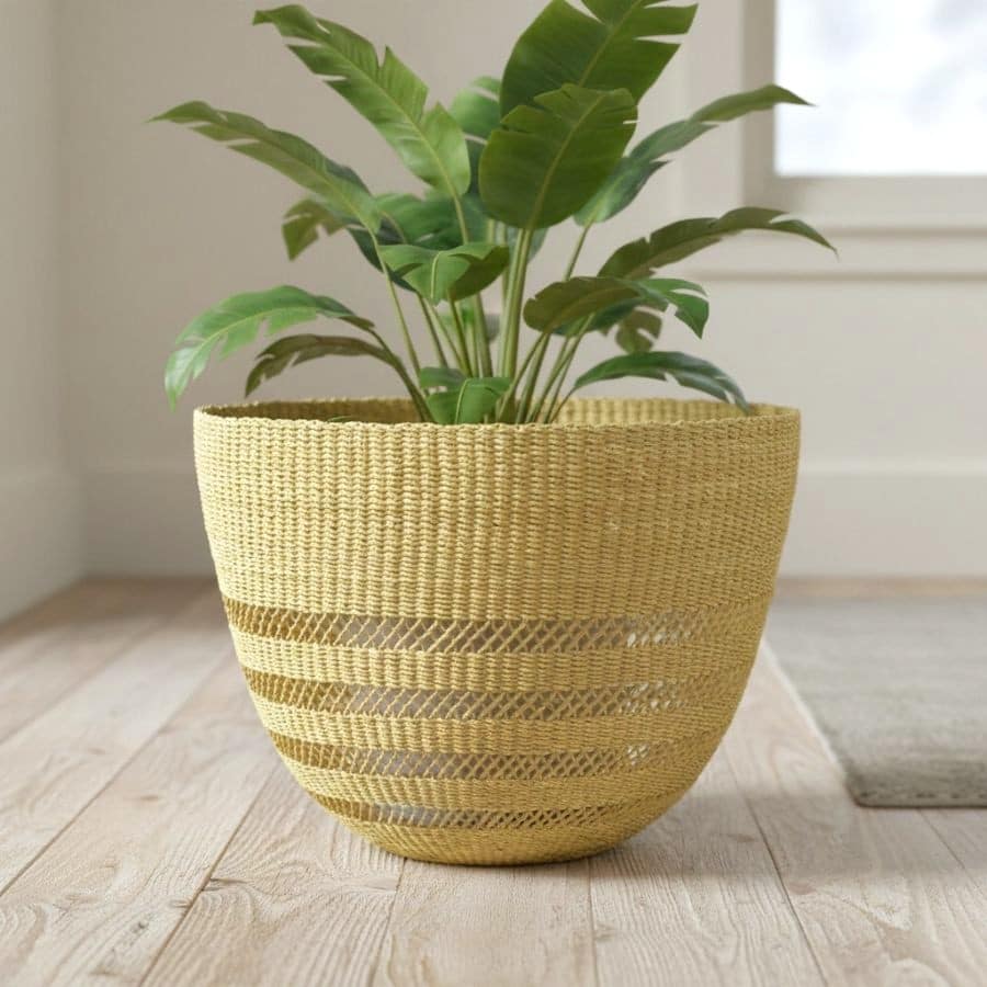 Natural open weave Bolga planter basket, handwoven in Bolgatanga Ghana from elephant grass, holding a leafy indoor plant
That's 118 characters, and it carries the entity signals (Bolga, Bolgatanga, elephant grass) that do the AIO work.
Two quick alternates depending on emphasis:
Shorter: Natural open weave Bolga planter basket in elephant grass, Bolgatanga Ghana (75 char)
Keyphrase-led, if you want "woven plant basket" in the alt too: Woven plant basket in a natural open weave, handmade in Bolgatanga Ghana from elephant grass
First one's my pick - it names the plant use, which suits a planter listing, while still leading with the product and origin.