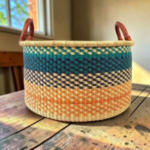 Large Bolga hamper basket photographed in a neutral home setting.