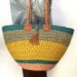 Round Ghana basket with leather handles.