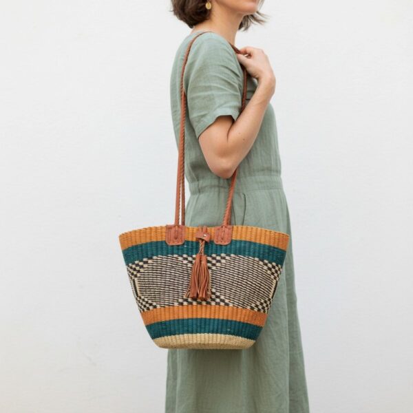 Hand-bag-187-skyline (1)-bashiri-shoulder-bag Handwoven Bolga shoulder bag with leather handles and tassel in teal, tan and natural stripes.
