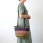 Traditional Ghanaian woven shoulder bag with stripe pattern and leather shoulder straps.