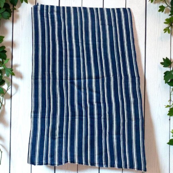 Expertly crafted blue fabric reflecting generational knowledge.