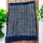 Detailed blue textile highlighting centuries-old weaving methods.