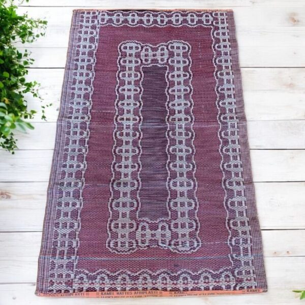 West African woven mat created from recycled materials for mindful home decoration.