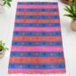 West African handwoven mat made from recycled fibers for practical home décor.