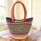 patterned long handle market basket woven from elephant grass