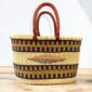 Handwoven Ghanaian basket showing natural variation in colour and pattern.