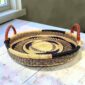 Bolga tray with leather handles styled on a wooden table by a window
