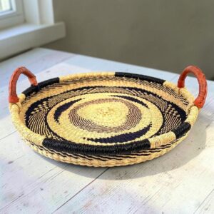 Bolga tray with leather handles styled on a wooden table
