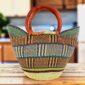 Classic market basket with a blocky geometric pattern in earthy tones and leather-wrapped handles