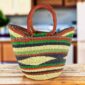 Classic market basket with bold multicolour stripes around a natural wave pattern and leather-wrapped handles