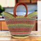 Classic market basket with chequered bands in muted, earthy tones and leather-wrapped handles