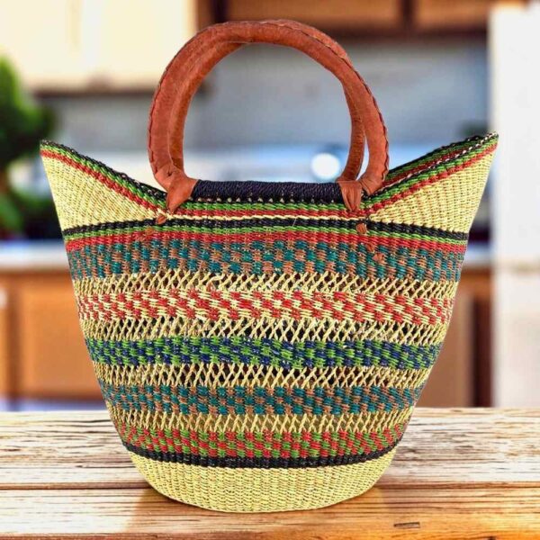 Classic market basket with an open weave and multicolour patterned bands and leather-wrapped handles