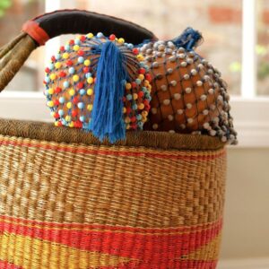 2 african gorund shakers in a woven basket