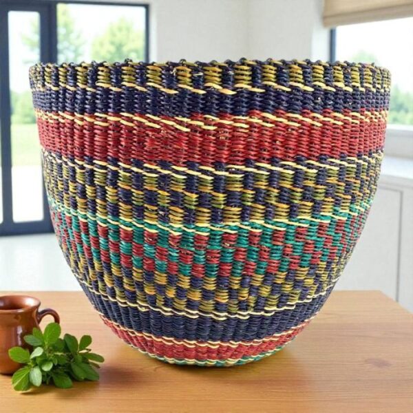 ashiri-woven-planter-basket-navy-red-multicolour Large woven planter basket in navy, red and multicolour stripe pattern on a timber bench