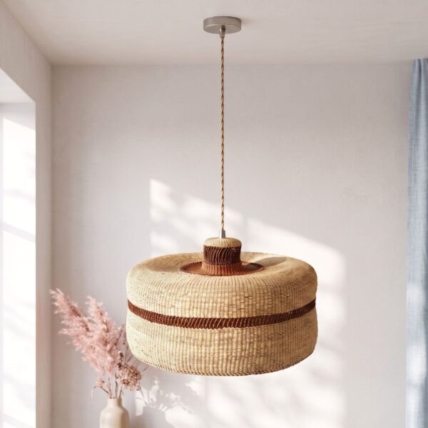 Woven bolga lampshade hanging with dried pampas grass, natural straw with a thin rust stripe