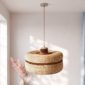 Woven bolga lampshade hanging with dried pampas grass, natural straw with a thin rust stripe