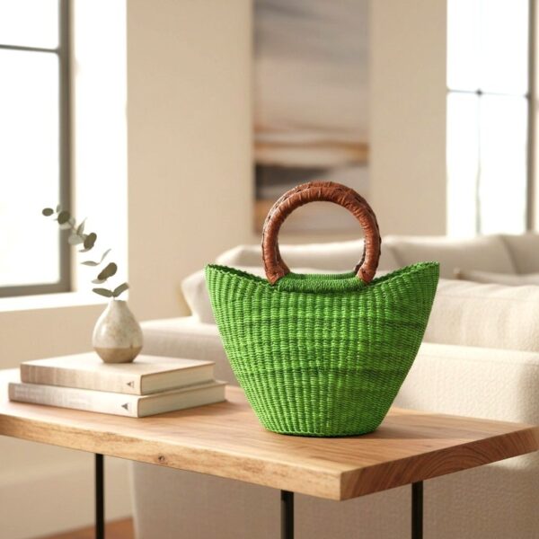 African bolga mini market basket in green on a wooden coffee table in a living room