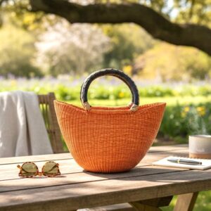 African bolga mini market basket in orange on an outdoor table