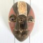 traditional nigerian ogoni mask in earthy painted colours