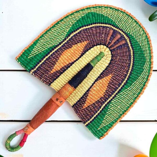 Woven Bolga hand fan in green and purple with a leather-wrapped handle
