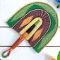 Woven Bolga hand fan in green and purple with a leather-wrapped handle