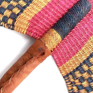 Close-up of the weave and leather handle on the pink and black Bolga fan