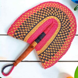 Woven Bolga hand fan in pink and black with a leather-wrapped handle