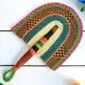 Woven Bolga hand fan in teal and pink with a leather-wrapped handle