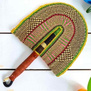 Woven Bolga hand fan in natural and yellow with a leather-wrapped handle