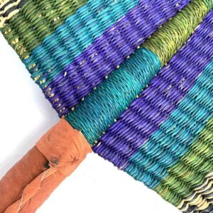 Close-up of the weave and leather handle on the blue and purple Bolga fan