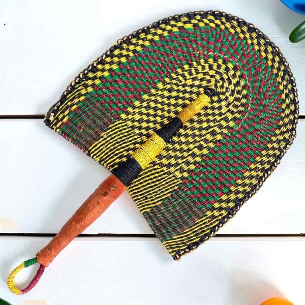 Woven Bolga hand fan in yellow and black with a leather-wrapped handle