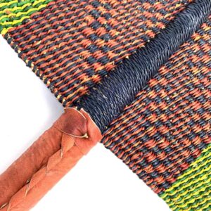 Close-up of the weave and leather handle on the lime and brown Bolga fan
