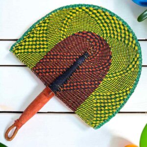 Woven Bolga hand fan in lime and brown with a leather-wrapped handle