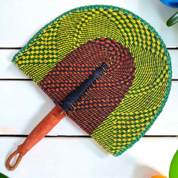 Woven Bolga hand fan in lime and brown with a leather-wrapped handle
