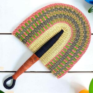 Woven Bolga hand fan in pink and natural with a leather-wrapped handle