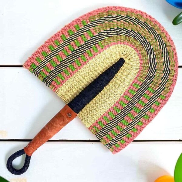 Woven Bolga hand fan in pink and natural with a leather-wrapped handle