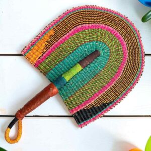 Woven Bolga hand fan in pink, olive and teal with a leather-wrapped handle