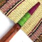 Close-up of the weave and leather handle on the orange and pink Bolga fan