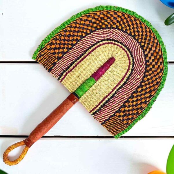 Woven Bolga hand fan in orange and pink with a leather-wrapped handle