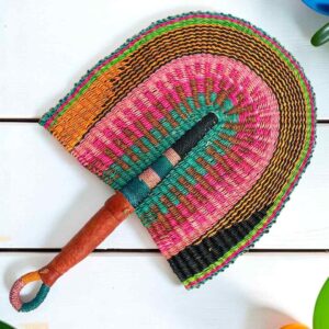 Woven Bolga hand fan in pink, teal and orange with a leather-wrapped handle