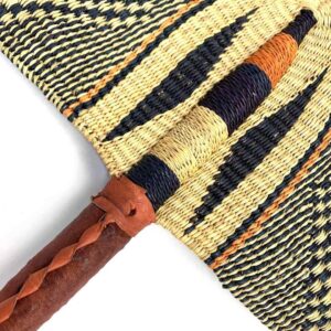 Close-up of the weave and leather handle on the black and natural Bolga fan