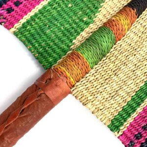 Close-up of the weave and leather handle on the green and pink Bolga fan